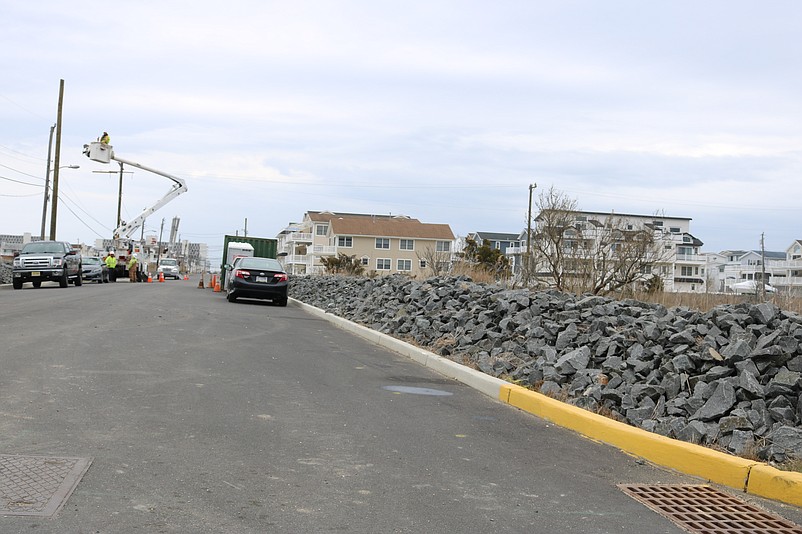 Rock walls, like this one running along the side of 38th Street, help contain flooding that seeps out of the marshlands.