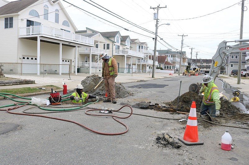 Workers with Utility Line Services dig trenches on 39th Street for gas service work.