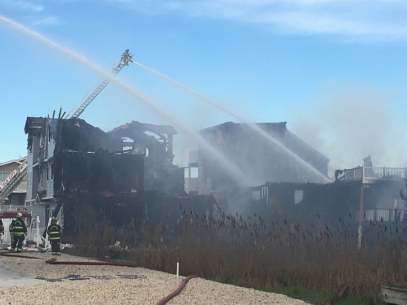 Firefighters continue to douse the charred remains of the duplexes Easter morning.