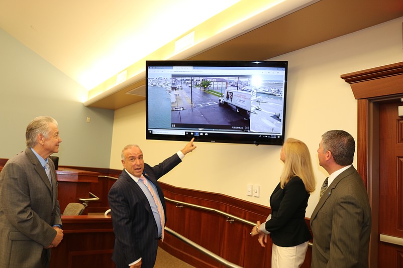 Sea Isle City Mayor Leonard Desiderio, center, looks at an image from the flood camera when it was first put into operation in 2019.