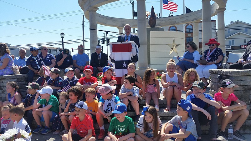 Children gather on the steps of the Veterans Park memorial during the 2019 Memorial Day ceremony.