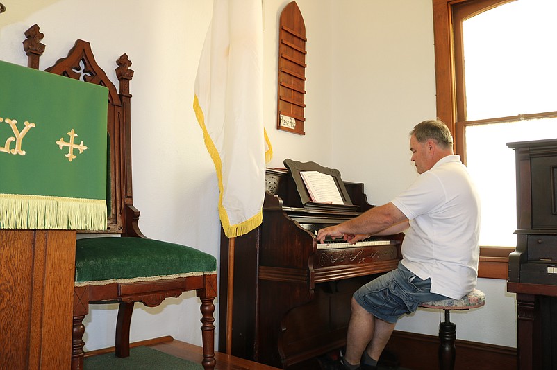 Shawn Quigley plays the church's antique organ, which he estimates to be more than 100 years old.