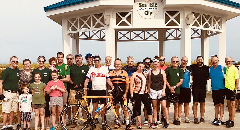 Fran Dolan, wearing  gray baseball cap, is joined by his fellow cyclists for a celebratory group photo after arriving in Sea Isle City in 2019.