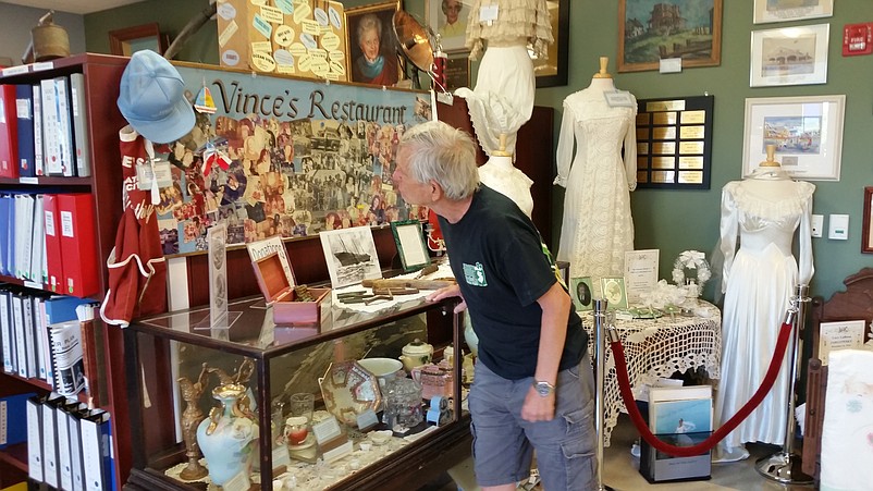 Museum visitor Pat McDonald looks at a photo collage of a former Sea Isle landmark.