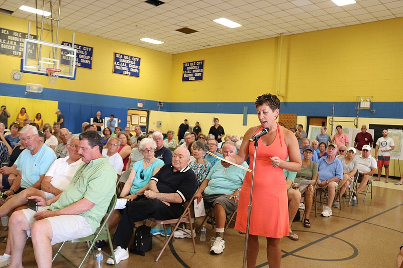 Jamie Mulholland speaks in favor of a community pool during a June meeting at the former school. 