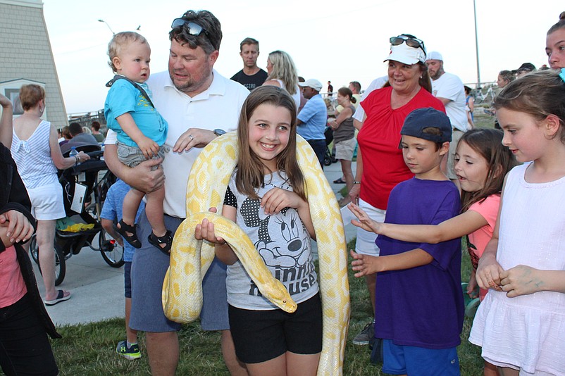 Families enjoy environmental exhibits, live music, face painters, bounce houses and the chance to pet exotic live animals.