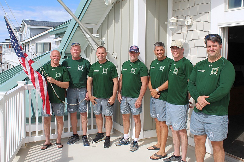 Chief Renny Steele (left) with beach patrol administrators, preparing to raise the American flag at SICBP Headquarters last Memorial Day.