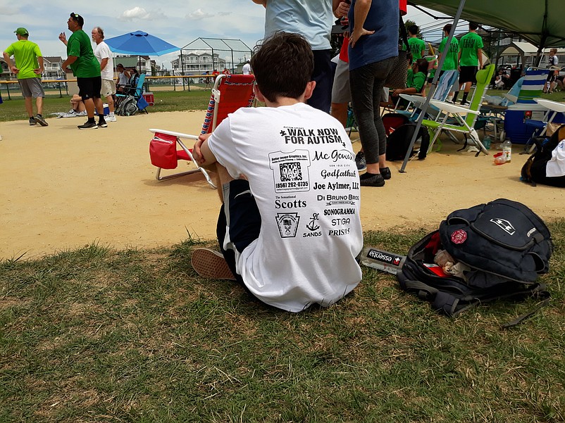 A T-shirt worn by one fundraising participant lists some of the sponsors that have supported autism-related causes.