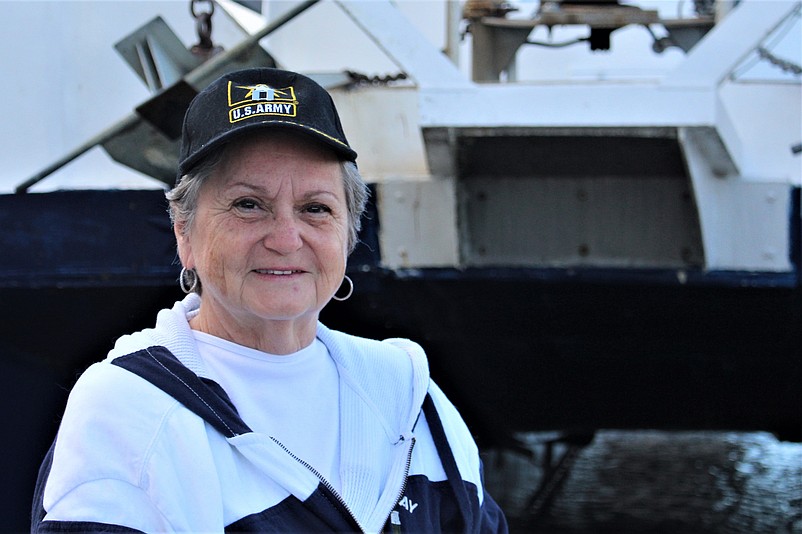 Mary Jane Muncey, a retired Army nurse and captain, wears a baseball cap decorated with the Army logo.