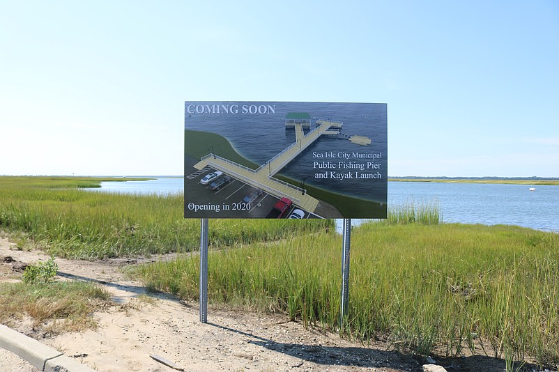 A large "Coming Soon" sign includes an architectural rendering that gives a sneak peek of the proposed kayak launch facility and fishing pier.