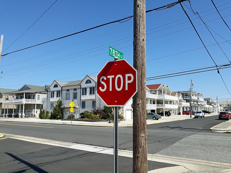 The old street signs with a green background have since been replaced with new signs with a black background and white lettering.