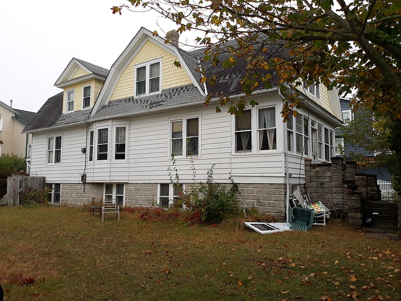 A side view of the house shows some of its distinctive architectural features.