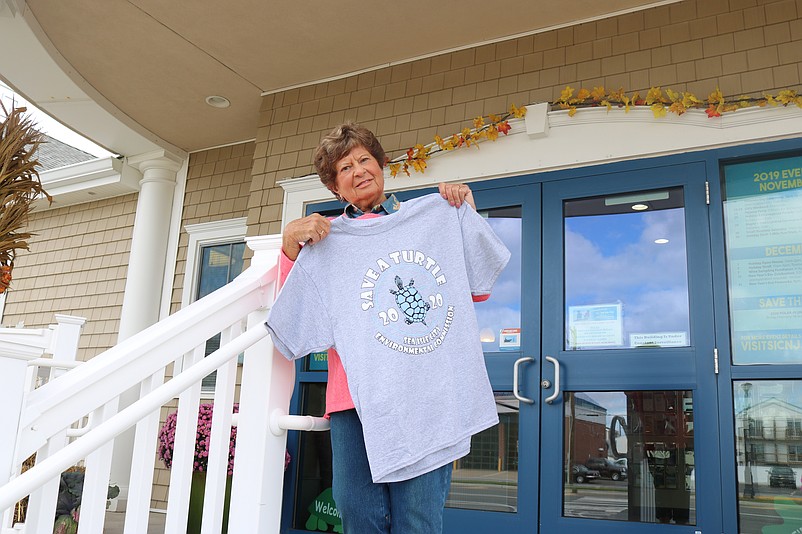 Chris Donohue, who works at the Sea Isle City Welcome Center, shows off one of the "Save a Turtle" T-shirts in 2020.