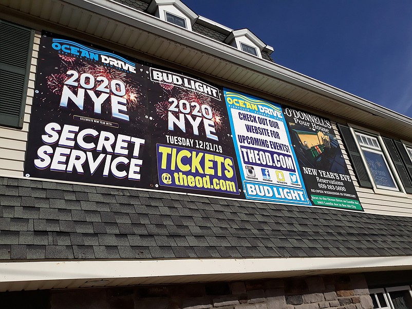 New Year's Eve advertisements for the Ocean Drive bar and sister property O'Donnell's Pour House overlook Landis Avenue.