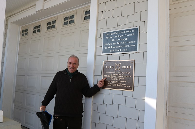 Mayor Leonard Desiderio celebrates the unveiling of a bronze plaque that commemorates the 100th anniversary of the Sea Isle City Beach Patrol.