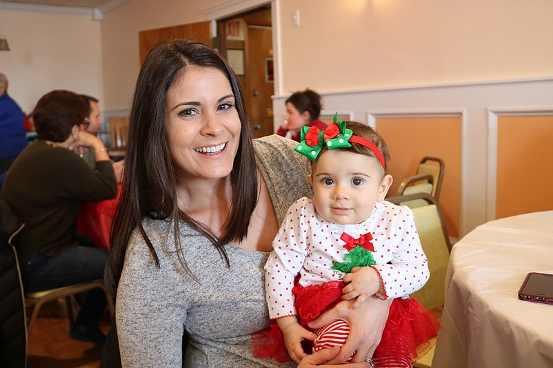 Alexa Campilango, of Sea Isle, holds her 8-month-old daughter, Giada, as big sis, Adriana gets her face painted.