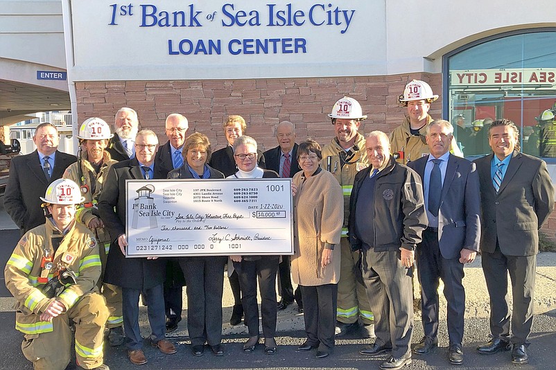 Members of Sea Isle City’s Volunteer Fire Department receive a $10,000 check from 1st Bank of Sea Isle City.