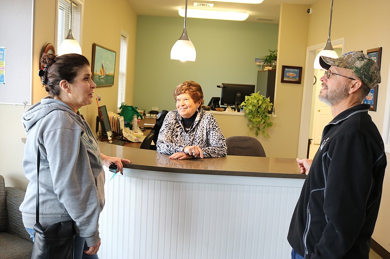 Kathy and Jeff Freund, of Glassboro, talk to Sea Isle City Welcome Center employee Chris Donohue, behind counter.