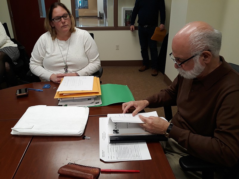 City Clerk Shannon Romano and City Engineer Andrew Previti review documents during the bid opening.