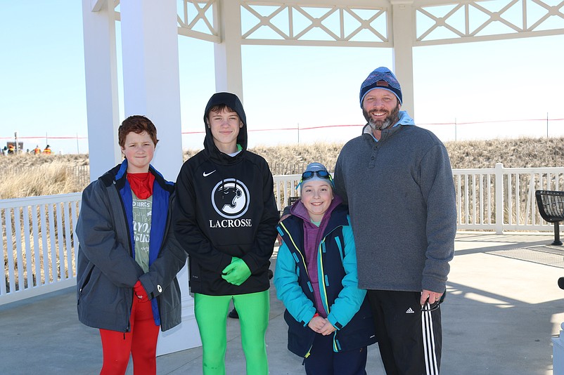 From left, friends Sean Sullivan, Chase Nangle, Sofie McClelland and Mike Sullivan, all of Delaware County, Pa., their first plunge. 