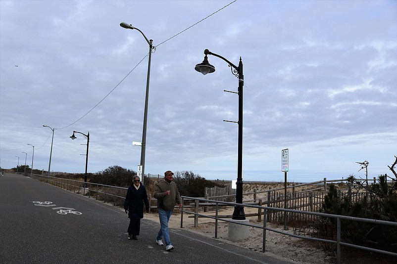 Sea Isle City couple Terry Downey and Pat Haffert walk by one of the new decorative lights.