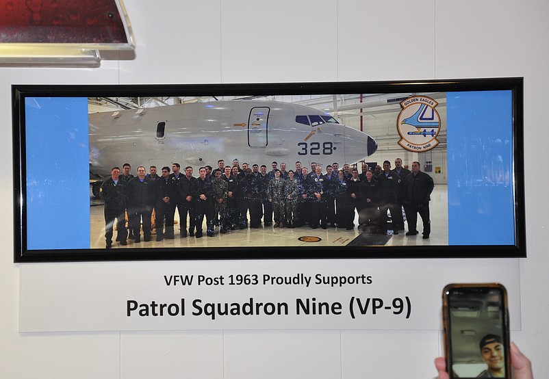 Patrol Squadron Nine in the photo and Anthony “Haas” Moore on phone via Skype. (Photo provided by Patti Lloyd)