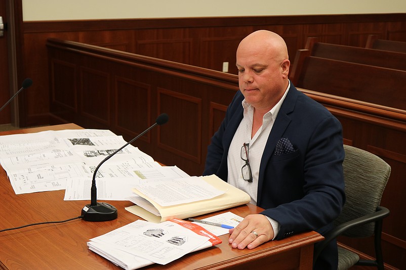 Local real estate agent Jamie Sofroney reviews his plans while addressing the Sea Isle Zoning Board members.