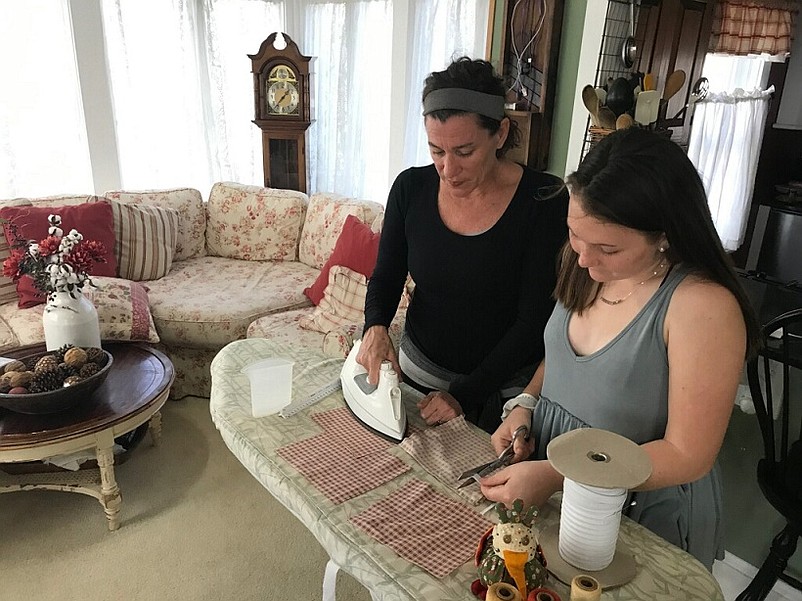 Tara Crowell and her daughter, Ellie Kutschera, are busy making masks to help protect people during the coronavirus pandemic. (Photo courtesy of Tara Crowell)