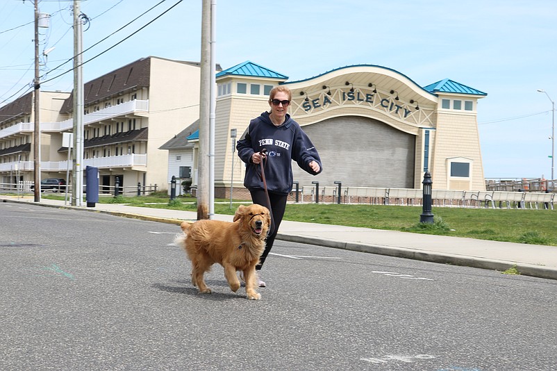 Maureen Szkaradnik takes an Easter jog down Pleasure Avenue with her dog, Gus.