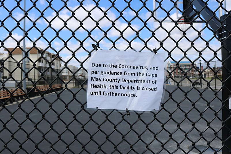 A sign attached to the fence surrounding one of the basketball courts explains why Sea Isle's recreation facilities are closed now.