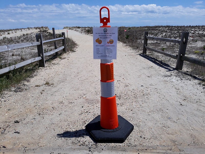 A sign at the entrance to the beach reminders everyone of the restrictions that are in place for now.