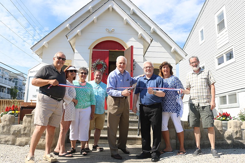 Republican congressional  candidate Bob Patterson and Pastor Chuck Swanson, center, lead a ribbon-cutting ceremony to open the church for the summer season.