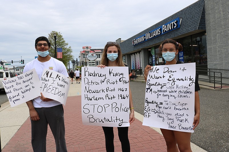 Aladdine Arbab and friends Juliana Crecelius, center, and Joselynn Bradshaw take a stand. 