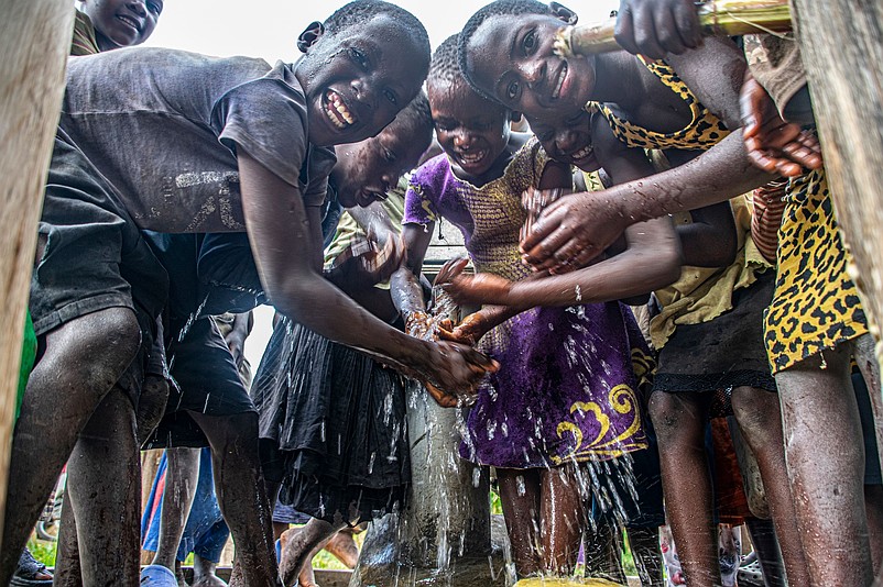 Children in Uganda celebrate having clean drinking water from a well that is dedicated in memory of Matt Vecere.  (Photo courtesy of Wells of Life)