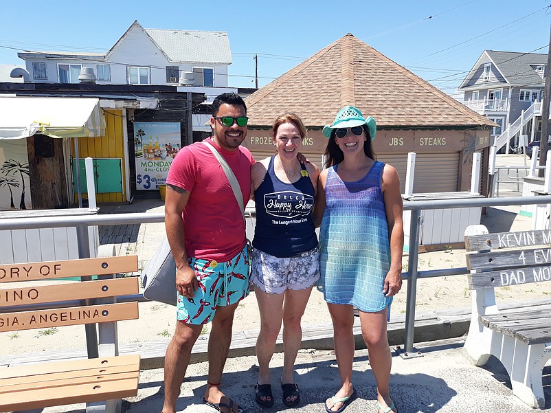 Former Springfield Inn customer Sue Elliott, center, is joined by her friends Yair Escudero and Joann Simmons for a photo in front of the old Carousel Bar.