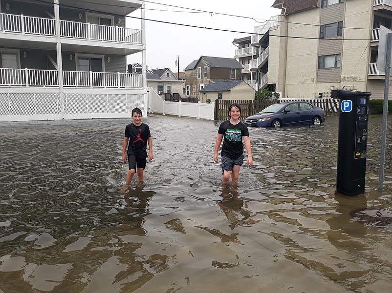 Stepbrothers Sean Harbison, 11, left, and Jack Mills, 10, are soaking wet after wading in floodwater on West Jersey Avenue.