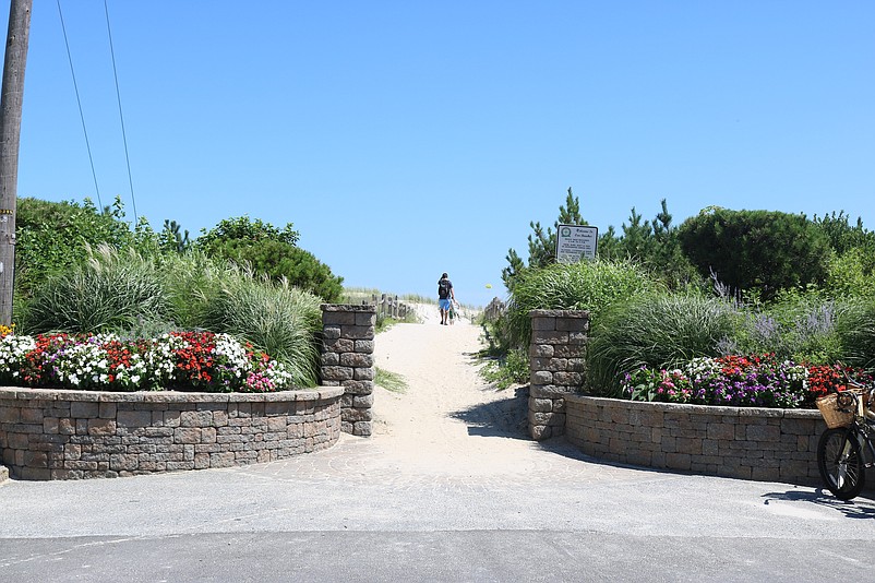 The entryway to the beach on Pleasure Avenue near 61st Street features an elaborate brick wall, columns, flowers and greenery.