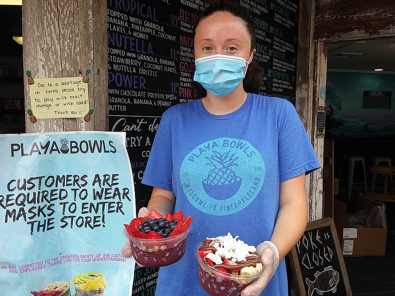 Ocean City Playa Bowls employee Mara McBane, of Egg Harbor Township, displays two juicy fruit bowls.