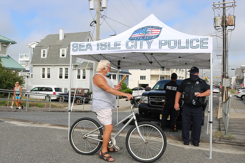 Biker Ernie Marcacci talks to Lt. William Mammele about cycling safety.