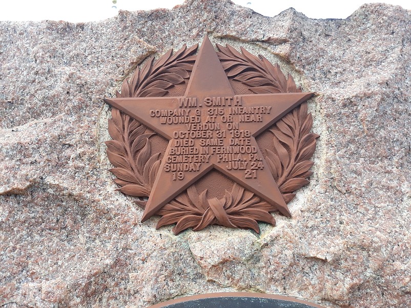 William Smith, who died in battle in 1918, is honored with a bronze five-point star surrounded by a memorial wreath.