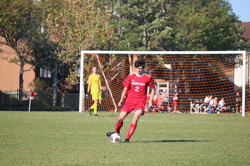 Senior Drew Tarr plays the ball in the midfield.