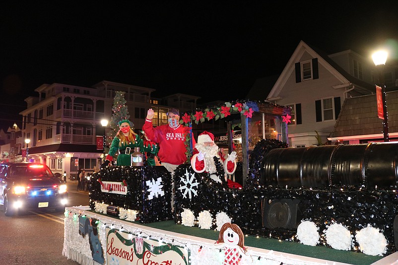 Santa Claus is joined by Mayor Leonard Desiderio while making a grand arrival in the 2020 Christmas parade aboard the Polar Express locomotive.