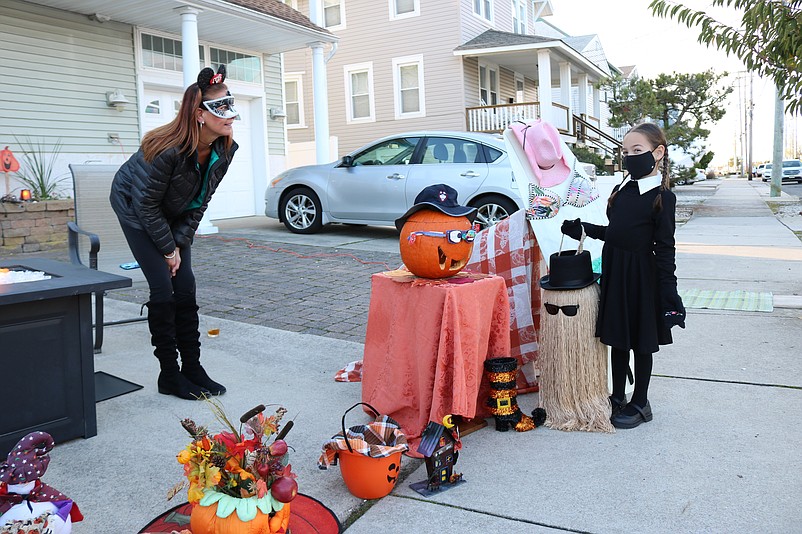 Trick-or-treater Audriana Galbiati, 5, dressed in her Wednesday Addams costume, stops in for some candy at Sea Isle resident Tina Cummiskey's Halloween display.