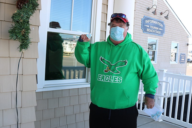 Tom Farrell, of Havertown, Pa., shows off one of the eight holiday beach tags he bought as stocking stuffers for his family.