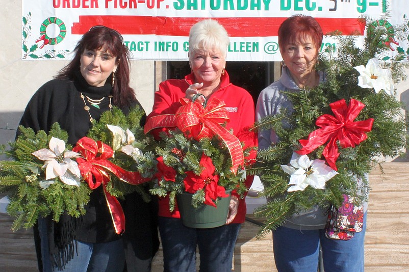 Shown during a previous Poinsettia and Wreath Sale are (from left) Club members Colleen Buch, Netta Otto and Joanne Morelli. (Photo courtesy Sea Isle City)