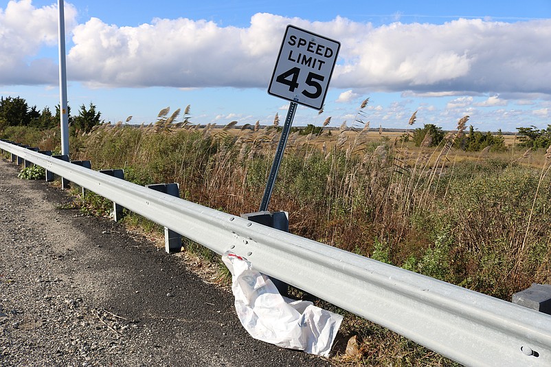 A large piece of plastic is wrapped around the guardrail next to a speed limit sign on Sea Isle Boulevard.