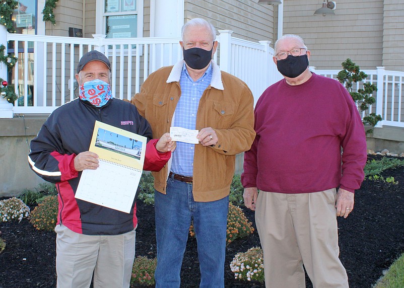 Photographer Jerry Hussar, center, presents a check for $250 to Mayor Leonard Desiderio for the Holiday Toy &amp; Food Drive. Joining them is City Councilman J.B. Feeley.