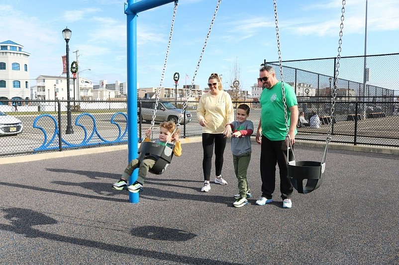 Kathleen and Kevin McKeever, of Philadelphia, watch as their 6-year-old son, Kevin Jr., gives a push to his little brother, Charles, 1, on the playground swing.