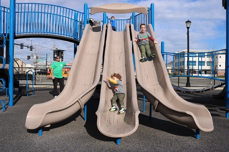 Sliding boards are one of the attractions at the playground on JFK Boulevard.