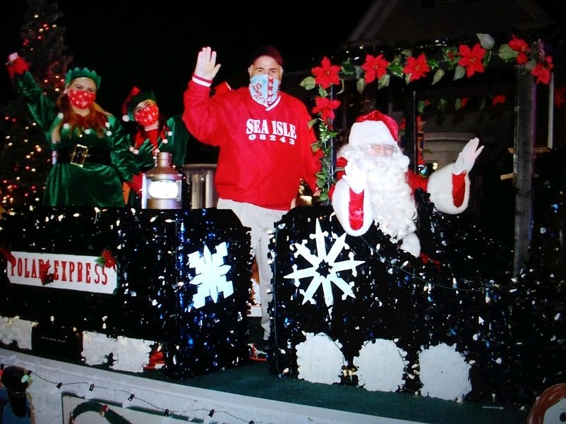 Joined by Mayor Leonard Desiderio, Santa Claus arrives in Sea Isle City's 2020 holiday parade aboard his Polar Express locomotive.